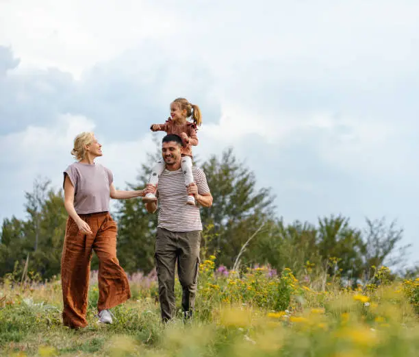 Happy Family Enjoying a Nature Walk in the Countryside Happy Family Enjoying a Nature Walk in the Countryside