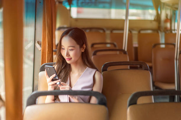 istock Asian Woman Using Smartphone While Seated on a Bus 2177880135