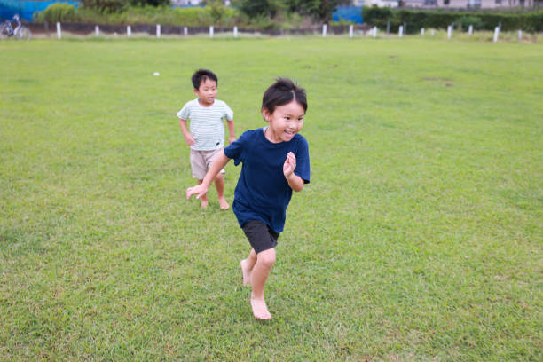 Children play engaging in physical activity in their local environment.Children being active, such as jumping, jogging, running, walking, playing.