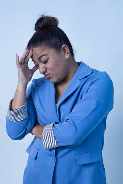 A businesswoman appears thoughtful and frustrated, showcasing emotional depth in a corporate environment.