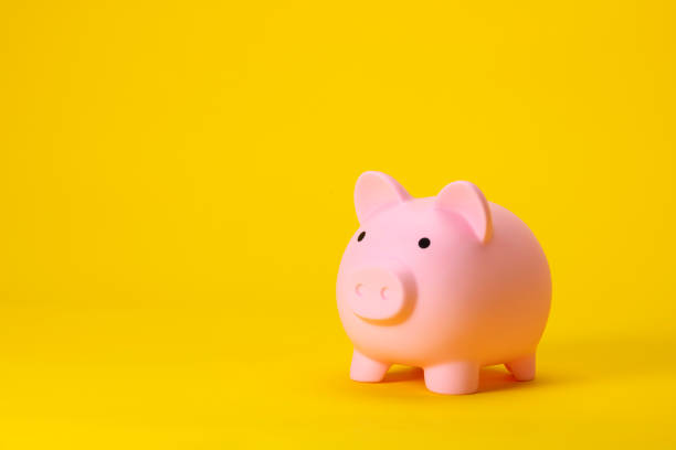 istock Pink Piggy Bank Isolated on Yellow Background 2177884280