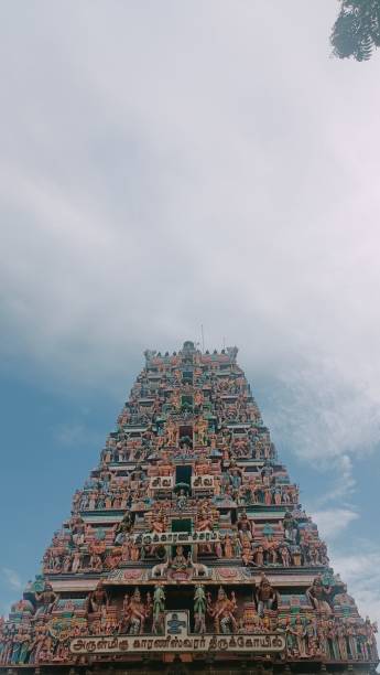 Tamil Temple entrence with gopuram rainy season Tamil Temple projects lots of statues and showing lots of feelings.kodi kambam is 1st entrance spot of temples entrence stock pictures, royalty-free photos & images