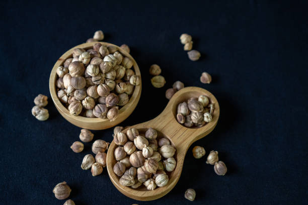Siam Cardamon, in wooden container on black background.