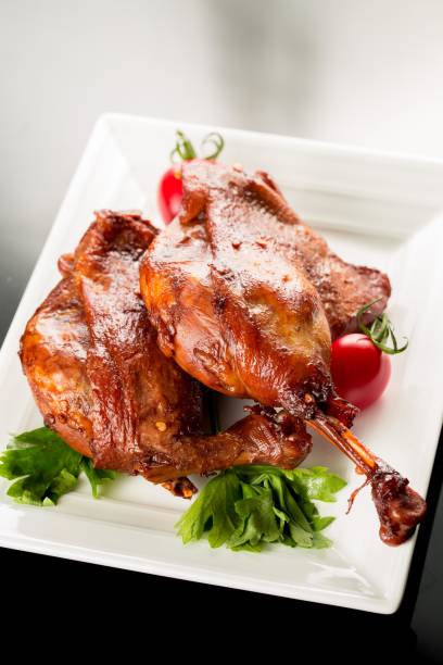 istock Duck confit with cherry tomatoes and parsley 2177896040