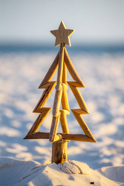 istock Driftwood Christmas tree with timber star in sand 2177897059