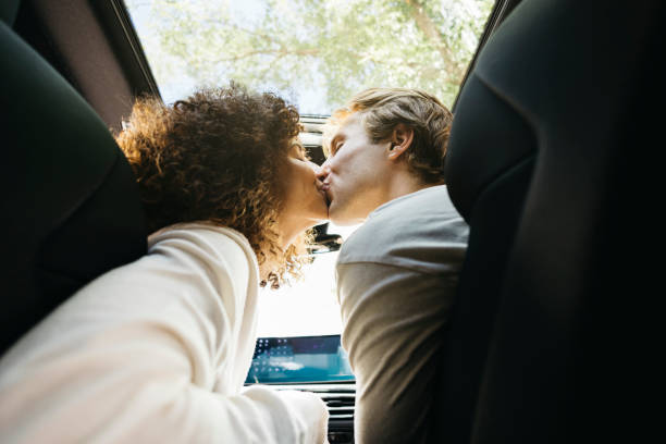 Couple sharing a romantic moment while charging electric car