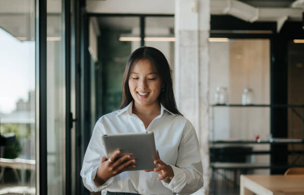 istock Young woman in office smiling while working 2177902912