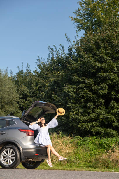 istock Woman Relaxing on SUV in Nature 2177904024