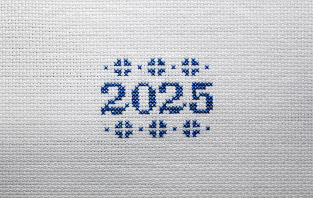 istock 2025 is embroidered with blue threads on white fabric. 2177905525