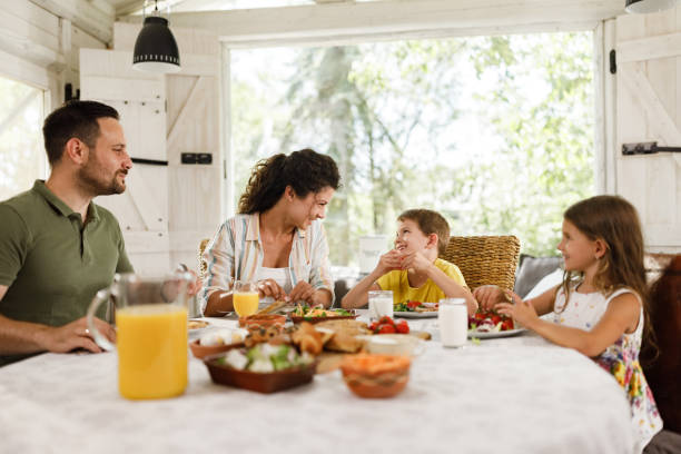 istock Happy family talking during breakfast at dining table. 2177906645