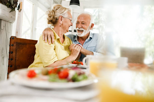 istock Embraced senior couple talking during a meal in dining room. 2177906887