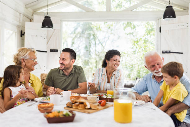 istock Happy extended family having a meal at dining table. 2177906917