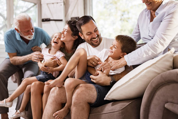 istock Playful extended family having fun on sofa at home. 2177906946
