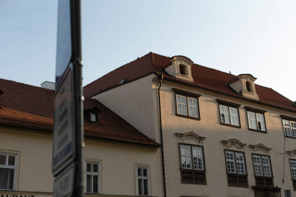 istock A white building with a bright red roof and a front sign 2177907407