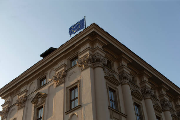 A substantial and impressive building that features a flag prominently waving on top of its rooftop, symbolizing its significance, location, or identity