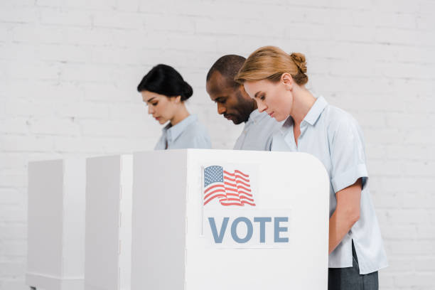 istock Voters engage in the democratic process inside polling booths during a local election 2177911394