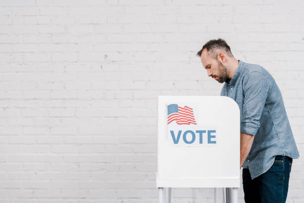 istock Voter casting his ballot in polling booth during a crucial election process 2177911401