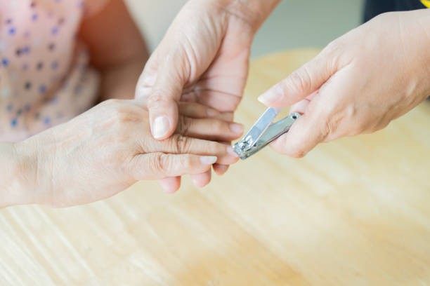 istock Manicure cutting on the older woman's nails on the table at home. Helping support to elder people concept 2177911412