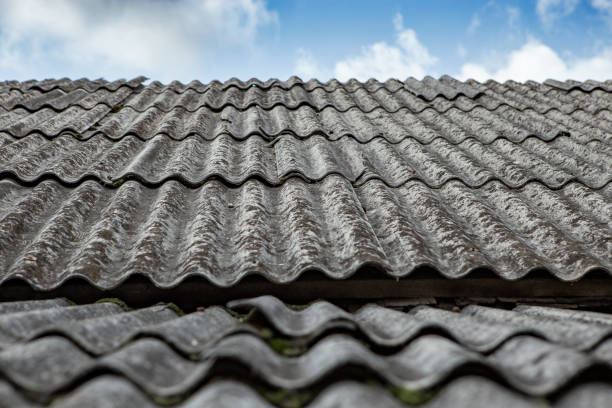 istock Gray asbestos sheets on a house rooof, pespective view with blue sky and white clouds 2177913379