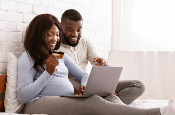 istock Happy expectant couple shopping online, using laptop 2177916759