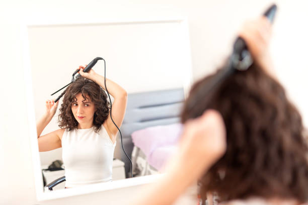 istock Young woman curling long hair 2177917552