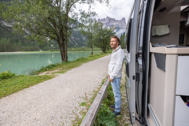 istock Man Opening Van Door by Mountain Lake 2177921060