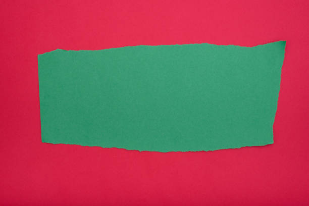 istock Green paper torn on both sides on red paper background. Blank space for text. 2177923257