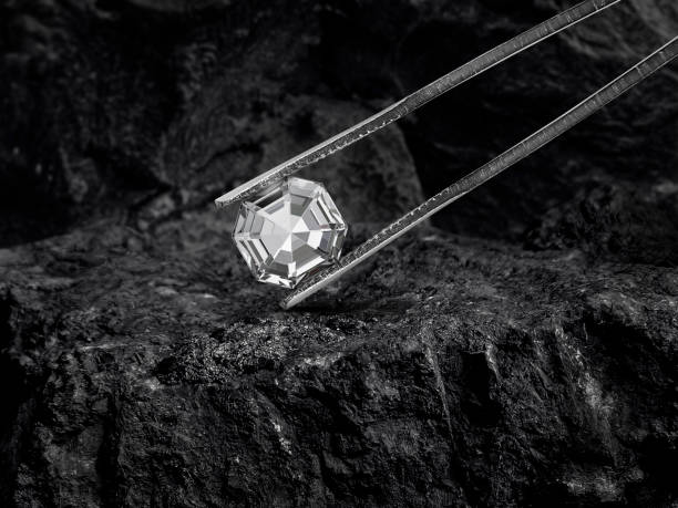 istock Cut Beautiful diamond held by tweezers on black coal background 2177924826