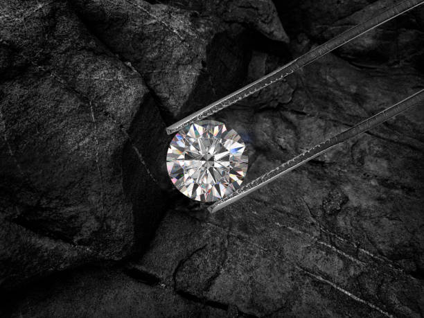 Cut Beautiful diamond held by tweezers on black coal background