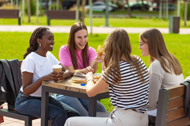 istock Chit-chat over drinks in the public park 2177925719