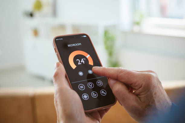 istock Senior man using mobile phone to control termostat at home 2177928850