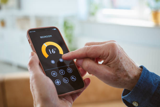 istock Senior man using mobile phone to control termostat at home 2177928873