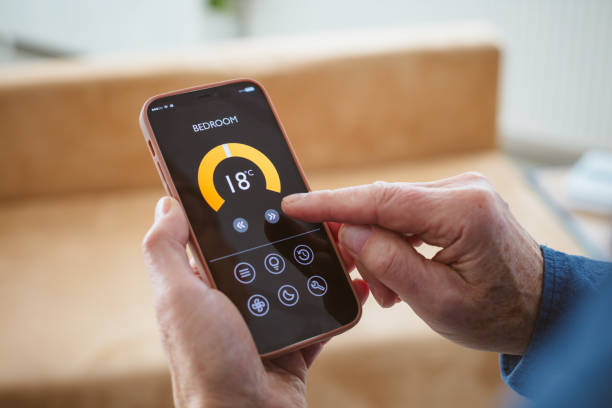 istock Senior man using mobile phone to control termostat at home 2177928899