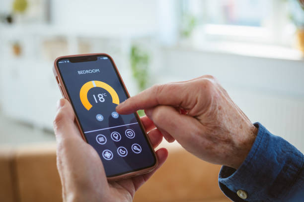 istock Senior man using mobile phone to control termostat at home 2177928932