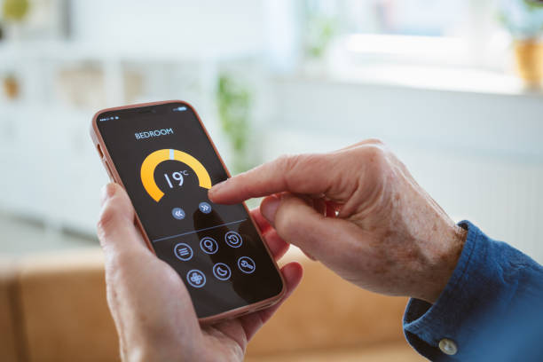 istock Senior man using mobile phone to control termostat at home 2177929107