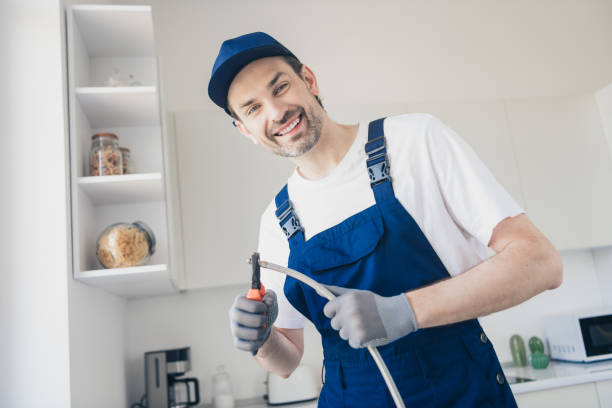 istock Smiling handyman in a modern kitchen working on appliance installation with professional tools and expertise 2177929416