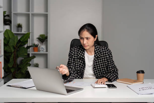 istock Stressed Businesswoman Facing Challenges at Work in Modern Office Setting with Laptop and Documents 2177930864