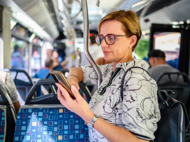 istock Woman using phone in public transportation while traveling 2177934329