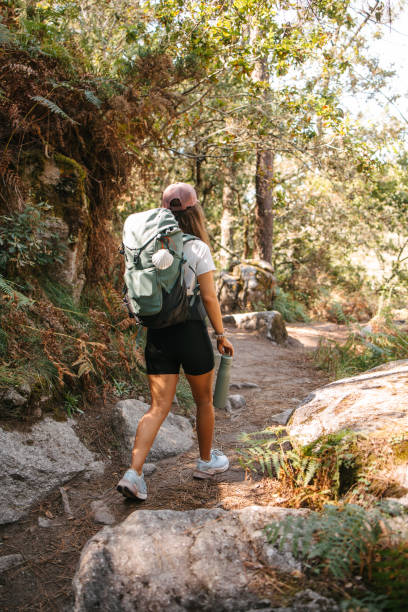 istock Backpacker walking in the woods holding a water battle 2177934856