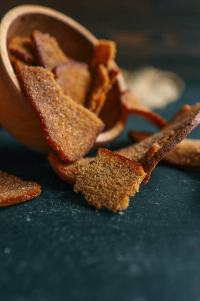 istock Wooden bowl filled with crispy rye croutons placed on a burlap cloth, creating a rustic snack presentation 2177935250