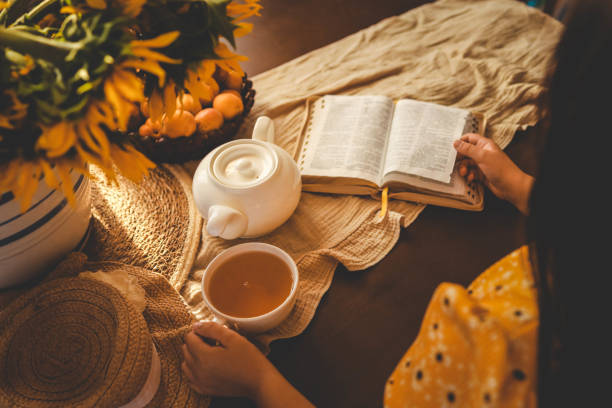 Girl reading bible, home evening atmosphere.