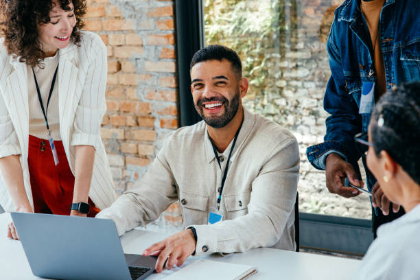 istock Content businessman leading a vibrant teamwork session with colleagues in a spacious, light-filled office 2177944773
