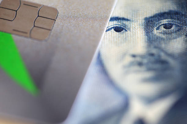 This image features a close-up view of a banknote alongside a credit card, highlighting elements of modern finance and payment transactions in a vibrant context.
