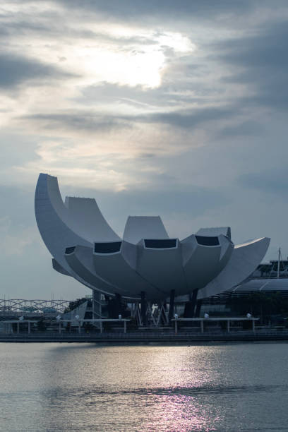 Singapore- 4 Oct 2024:  Beautiful sunrise with Singapore Art Science Museum as seen from Merlion Park. The architecture is said to be a form reminiscent of a lotus flower.