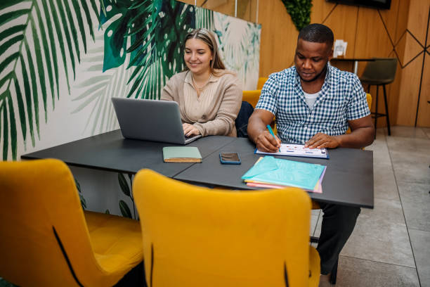 istock Colleagues working together and planning activities while sitting in front of laptop 2177950802