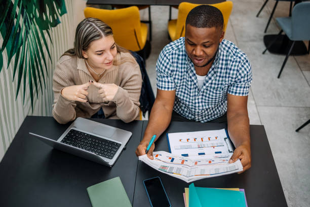 istock Colleagues working together going through charts and looking at laptop 2177950809
