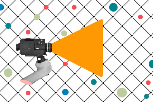 A hand holding a super 8 camera on a white background with black lines and colored polka dots