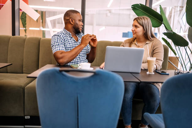 istock Colleagues working together while on a coffee break sitting in front of laptop 2177951114