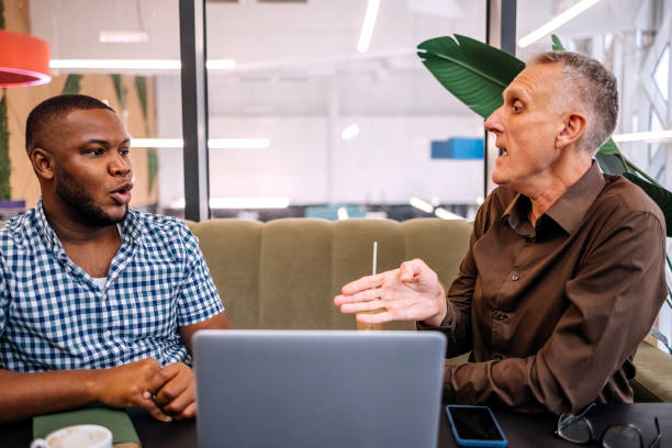 istock Colleagues working together while on a coffee break sitting in front of laptop 2177951168