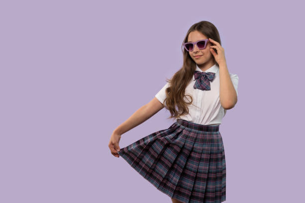 istock Young girl holding skirt while posing confidently 2177951177